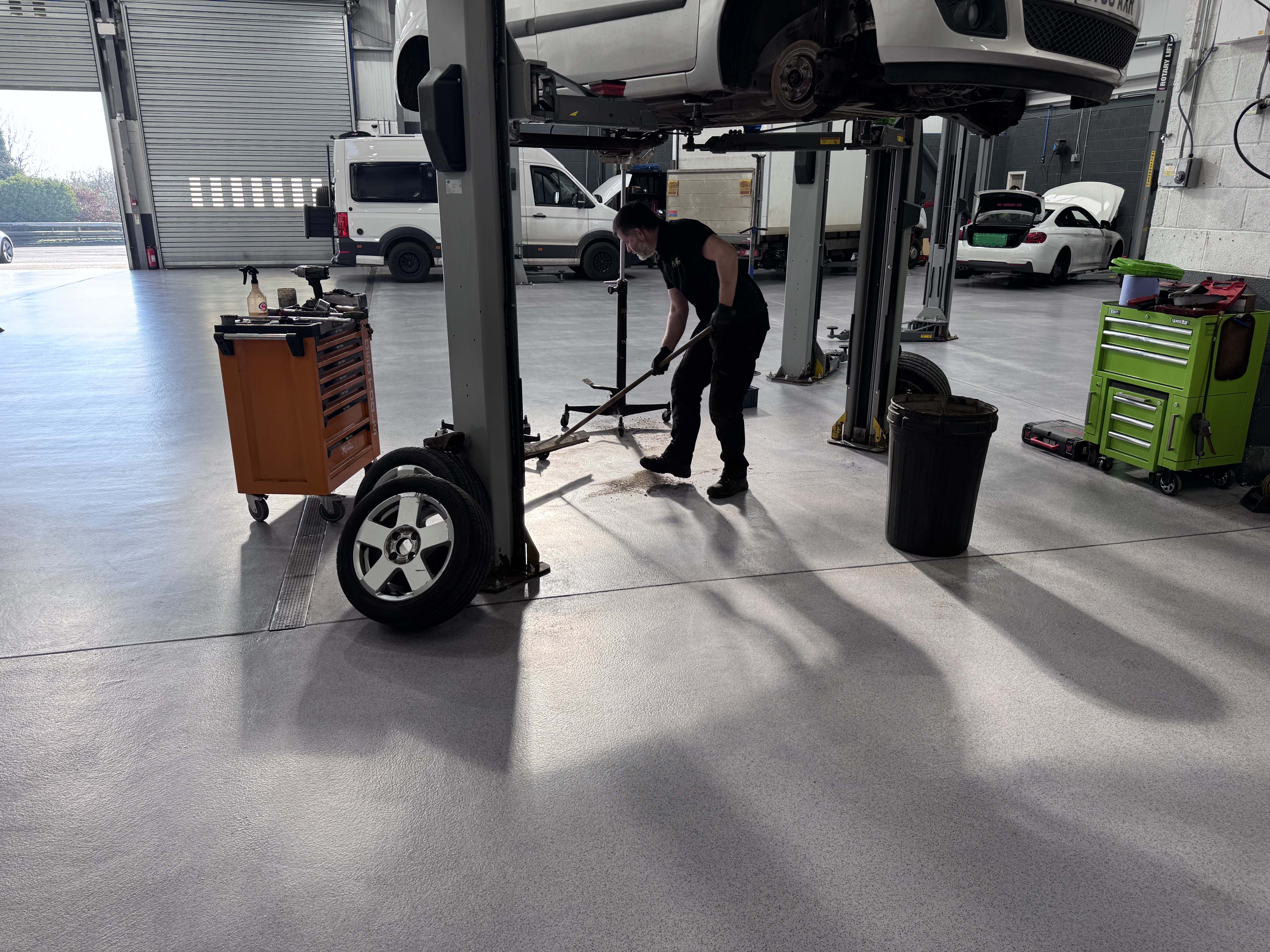 Acrylicon resin flooring in a car garage with a vehicle on a ramp