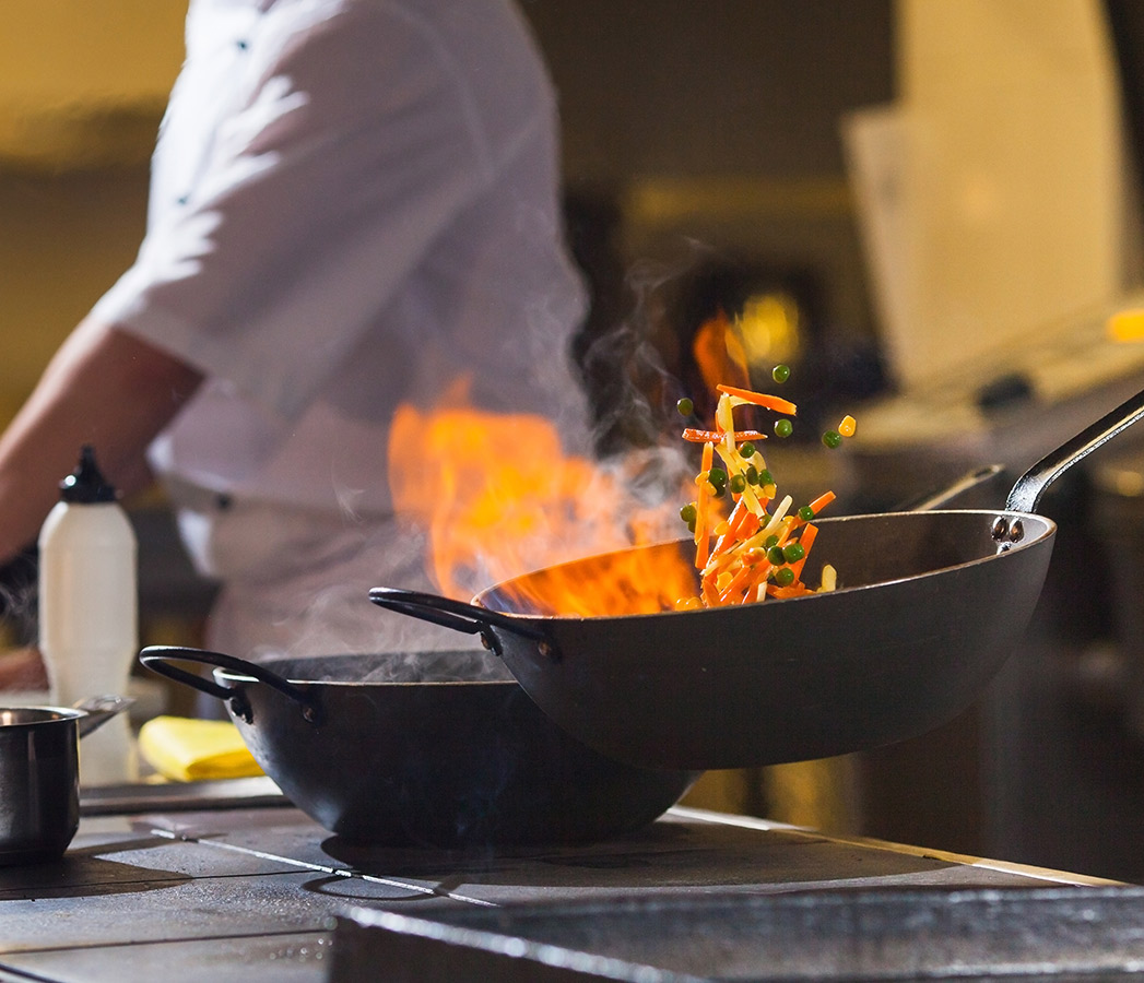 Chefs at work in a commercial food service kitchen