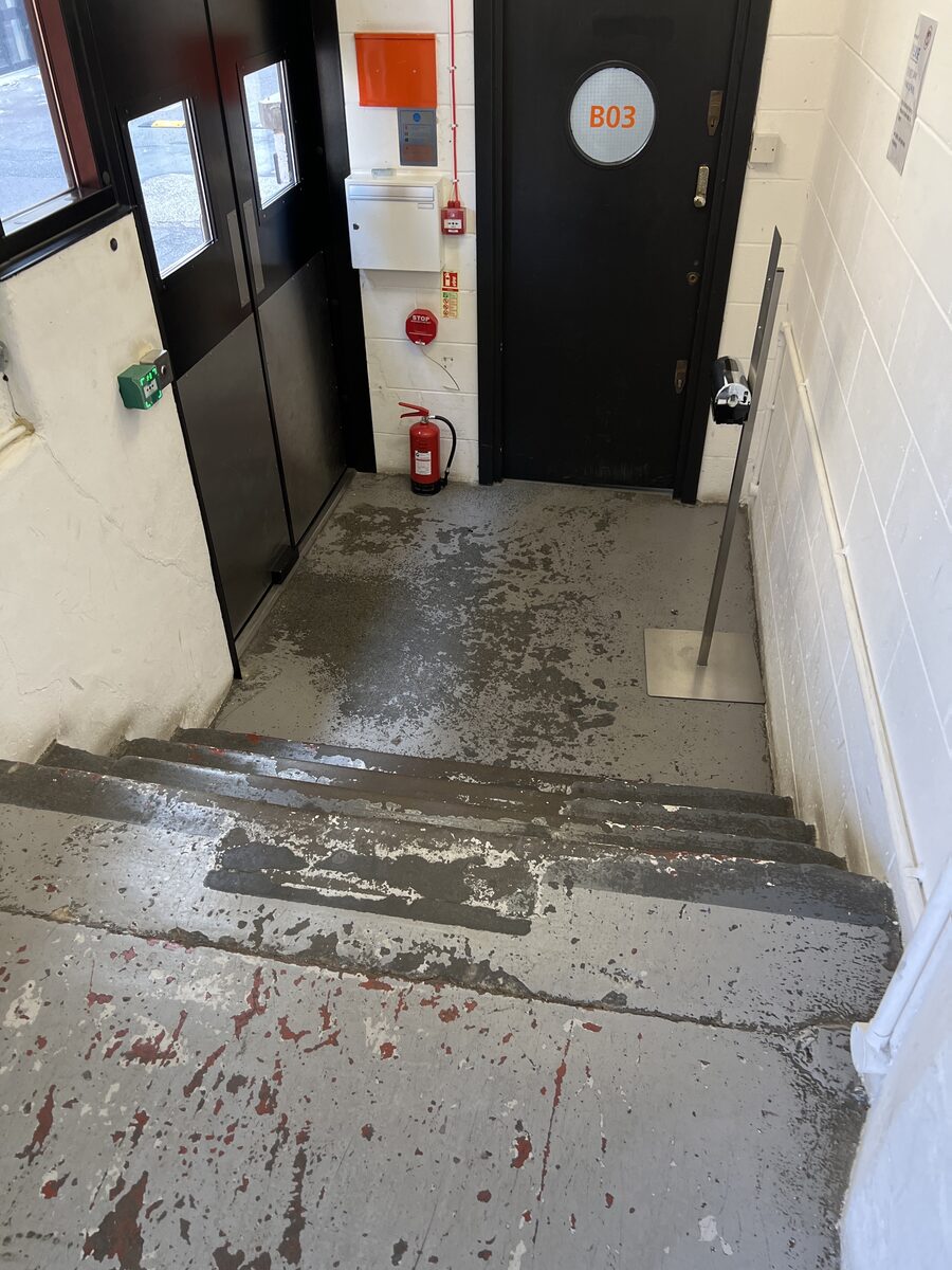 Worn concrete stairs and entrance at the Biscuit Factory before refurbishment