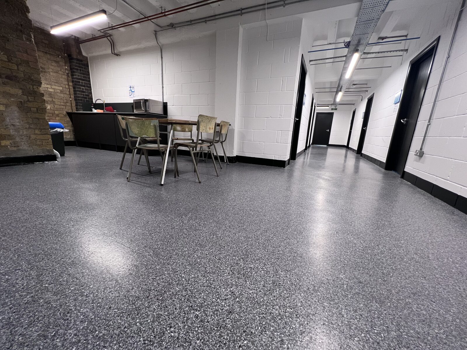 Acrylicon Flake System flooring in a shared kitchen space at the Biscuit Factory